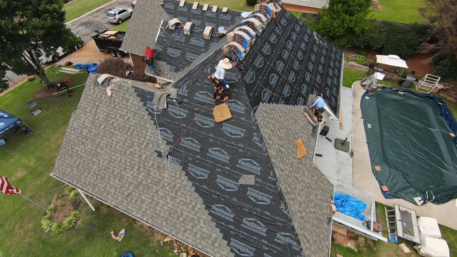 Bluebird Roofing crew installing a new roof, seen from above