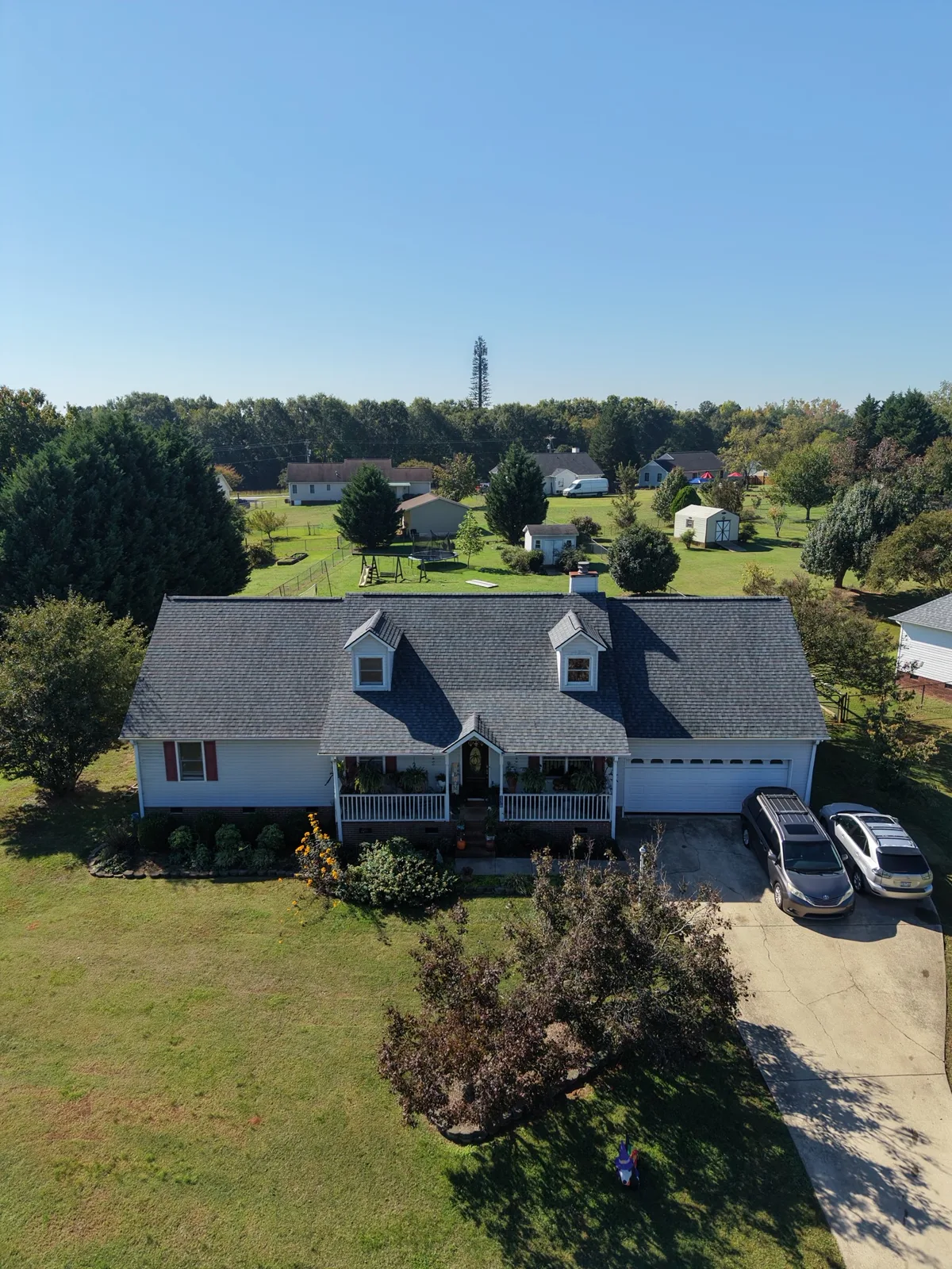 Aerial view of a home with a freshly installed gray shingle roof